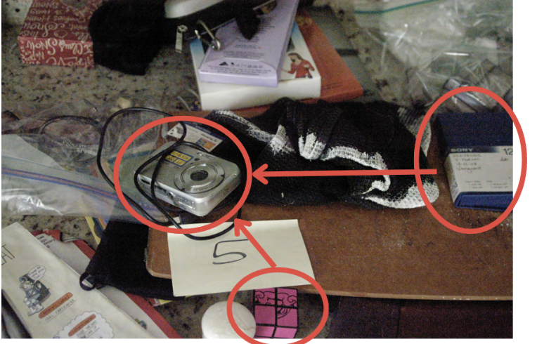 FBI search photo — same countertop, Sony Cybershot now appears