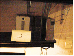 FBI search photo 34 — bookshelf showing 3 devices, with Item 2 label