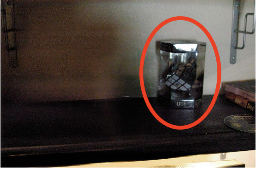 Reconstruction — encased Rubik's Cube of unknown origin placed on shelf